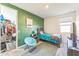 bedroom with green walls, twin bed, and closet at 453 E Wiley Way, Casa Grande, AZ 85122