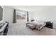 Main bedroom with plush carpet and a king-size bed at 453 E Wiley Way, Casa Grande, AZ 85122