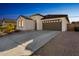 Charming one-story home with a brown garage door and desert landscaping at 453 E Wiley Way, Casa Grande, AZ 85122