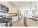 Open kitchen with stainless steel appliances and an island at 453 E Wiley Way, Casa Grande, AZ 85122