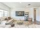Bright living room featuring a comfortable sofa and large TV at 453 E Wiley Way, Casa Grande, AZ 85122