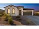 Charming one-story home with a brown garage door and desert landscaping at 453 E Wiley Way, Casa Grande, AZ 85122