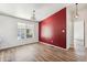 Bright dining area with hardwood floors and red accent wall at 11596 W Sierra Dawm Blvd # 192, Surprise, AZ 85378