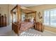 Spacious bedroom with a large four-poster bed and ample natural light at 3291 E Latham Way, Gilbert, AZ 85297