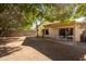 Spacious backyard with covered patio and mature trees at 1018 W Juniper Ave, Gilbert, AZ 85233