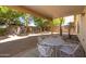 Covered patio with table and chairs, overlooking a spacious backyard at 1018 W Juniper Ave, Gilbert, AZ 85233