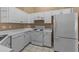 White kitchen cabinets, appliances and tile floor at 1018 W Juniper Ave, Gilbert, AZ 85233