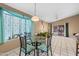 Cozy dining area with glass table and four chairs, near the kitchen at 1018 W Juniper Ave, Gilbert, AZ 85233