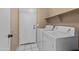Laundry room with washer, dryer, and shelving at 1018 W Juniper Ave, Gilbert, AZ 85233