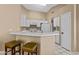 Kitchen with white cabinets, a breakfast bar and appliances at 1018 W Juniper Ave, Gilbert, AZ 85233