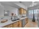 Modern kitchen with stainless steel appliances, quartz countertops, and light wood cabinets at 14950 W Mountain View Blvd # 1105, Surprise, AZ 85374