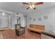Bright living room featuring a comfy couch and an armchair, hardwood floors, and a ceiling fan at 14950 W Mountain View Blvd # 1105, Surprise, AZ 85374