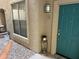 Front entrance with teal door and small front yard at 14950 W Mountain View Blvd # 1105, Surprise, AZ 85374