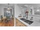 Modern kitchen with double sink, stainless steel appliances, and light wood cabinets at 14950 W Mountain View Blvd # 1105, Surprise, AZ 85374