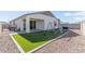 Artificial turf backyard with playset and patio area at 9820 E Satellite Dr, Mesa, AZ 85212