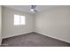 Simple bedroom with carpet, window, and ceiling fan at 8319 E Palm Ln, Scottsdale, AZ 85257