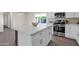 Modern kitchen features a large island, stainless steel appliances, and white cabinetry at 8319 E Palm Ln, Scottsdale, AZ 85257