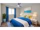 Bedroom with blue bedding, window and ceiling fan at 8319 E Palm Ln, Scottsdale, AZ 85257
