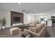 Open concept living room features neutral furniture, a large TV, and ample natural light at 8319 E Palm Ln, Scottsdale, AZ 85257