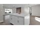 White kitchen island with quartz countertop and modern bar stools at 8319 E Palm Ln, Scottsdale, AZ 85257