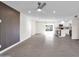 Bright living room with tile floors, modern wall accent, and access to kitchen and dining area at 8319 E Palm Ln, Scottsdale, AZ 85257