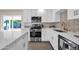Modern kitchen with white cabinets, stainless steel appliances, and quartz countertops at 8319 E Palm Ln, Scottsdale, AZ 85257