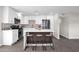 Modern kitchen with white island, stainless steel appliances, and wood accent wall at 8319 E Palm Ln, Scottsdale, AZ 85257
