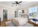 Bright bedroom featuring hardwood floors, large windows, and access to a bathroom at 1921 E Yale St, Phoenix, AZ 85006