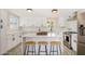 Updated kitchen featuring white shaker cabinets, quartz countertops, and an island with seating at 1921 E Yale St, Phoenix, AZ 85006
