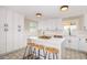 Bright kitchen boasts white cabinets, quartz countertops, and an island with bar stools at 1921 E Yale St, Phoenix, AZ 85006