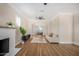 Open living space with hardwood floors, fireplace and view into kitchen at 1921 E Yale St, Phoenix, AZ 85006