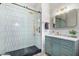 Modern bathroom with hexagon tile shower and teal vanity at 1921 E Yale St, Phoenix, AZ 85006