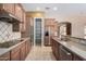 Kitchen boasts granite countertops and ample wood cabinetry at 2652 N 143Rd Dr, Goodyear, AZ 85395