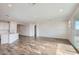 Bright living room with tile floors and sliding glass doors at 36545 W Leonessa Ave, Maricopa, AZ 85138