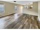 Bright living room with wood-look floors and views into kitchen area at 11534 W Bloomfield Rd, El Mirage, AZ 85335