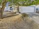 House exterior with a walkway, driveway, and mature tree at 11534 W Bloomfield Rd, El Mirage, AZ 85335