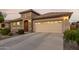 Two-story house with stone facade and three car garage at 6181 S Granite Dr, Chandler, AZ 85249