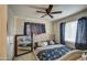 Primary bedroom with tufted headboard and ceiling fan at 8836 N 28Th Dr, Phoenix, AZ 85051