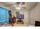 Bedroom with ceiling fan, dresser, and large TV at 8836 N 28Th Dr, Phoenix, AZ 85051