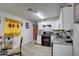 Clean kitchen with white cabinets, granite counters, and a glass-top stove at 8836 N 28Th Dr, Phoenix, AZ 85051