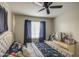 Bedroom with a ceiling fan and blue curtains at 8836 N 28Th Dr, Phoenix, AZ 85051