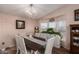 Bright dining room with bay window, hardwood floors, and a farmhouse style table at 2650 W Union Hills Dr # 344, Phoenix, AZ 85027