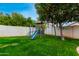 Grass backyard with playset and fruit tree, ideal for children at 4601 E Carolina Dr, Phoenix, AZ 85032