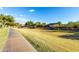 Concrete walkway winds through a well-manicured community lawn at 5423 W Range Mule Dr, Phoenix, AZ 85083