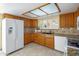 Kitchen with wood cabinets, granite countertops, and white appliances at 1017 E Grandview Rd, Phoenix, AZ 85022