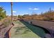 Landscaped backyard with putting green and desert landscaping at 1017 E Grandview Rd, Phoenix, AZ 85022