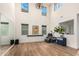 High-ceiling living room with hardwood floors and large windows at 9452 E Saturn Ave, Mesa, AZ 85212