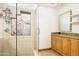 Bathroom with glass shower, stone tile, and updated vanity at 4636 E Moonlight Way, Paradise Valley, AZ 85253