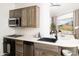 Modern kitchen featuring stainless steel appliances and mountain views at 4636 E Moonlight Way, Paradise Valley, AZ 85253