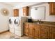 Bright laundry room with washer, dryer, and custom cabinetry at 4636 E Moonlight Way, Paradise Valley, AZ 85253